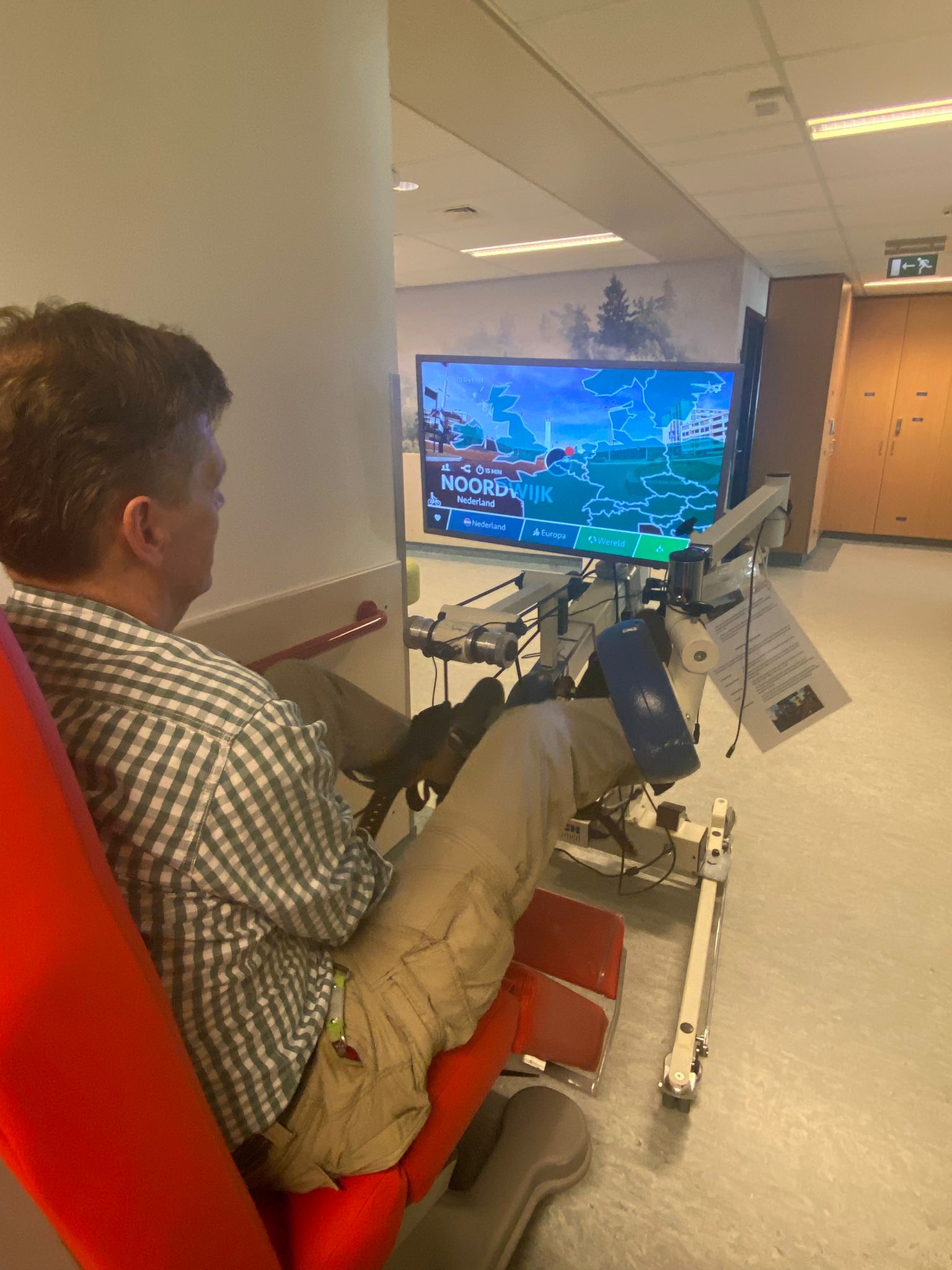 A member of UMC staff is using a dialysis exercise bike